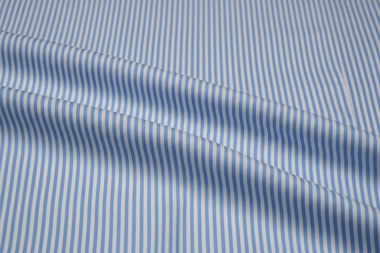 create this Sky Blue Stripe Poplin (Executive Comfort Classic)
• Category: Business Formal / Executive Office
• Fabric: 97% Long-Staple Egyptian Giza Cotton + 3% Lycra
• Yarn Count: 80/2 × 80/2
• Weight: 130 g/m²
• Weave: Poplin (Plain Weave)
• Finish: Double Mercerized, Liquid Ammonia Softened, Nano
Wrinkle-Resistant, Easy-Iron
• Pantone: 15-3920 “Sky Blue” × 11-0601 “White”